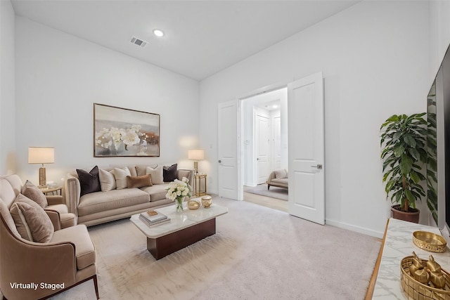carpeted living area featuring visible vents, recessed lighting, and baseboards