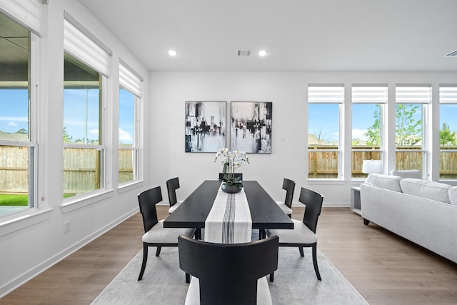 dining space with baseboards, recessed lighting, wood finished floors, and visible vents