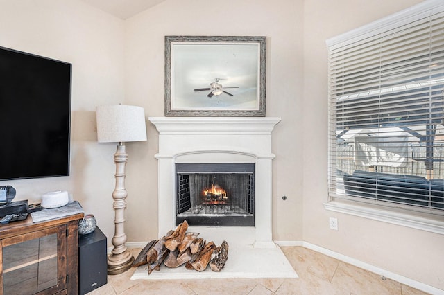 23414 Bracino Lake Dr, Katy, TX 77493 - interior details with baseboards, ceiling fan, and a warm lit fireplace