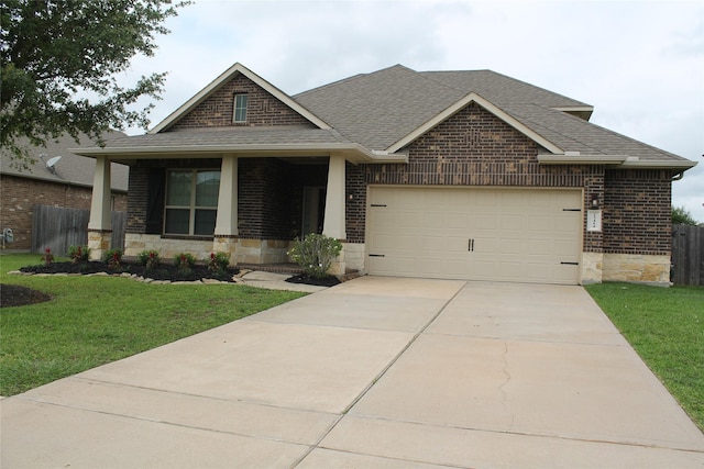 23414 Bracino Lake Dr, Katy, TX 77493 - craftsman inspired home with a front yard, a garage, brick siding, a shingled roof, and stone siding