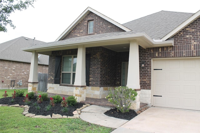 23414 Bracino Lake Dr, Katy, TX 77493 - doorway to property featuring a shingled roof, an attached garage, stone siding, and brick siding