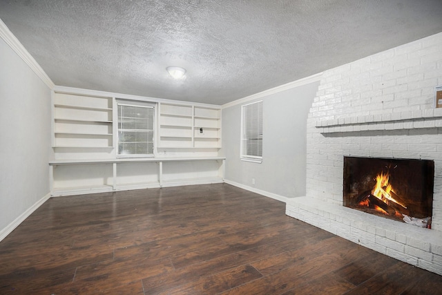 unfurnished living room with ornamental molding, a textured ceiling, a brick fireplace, and wood finished floors