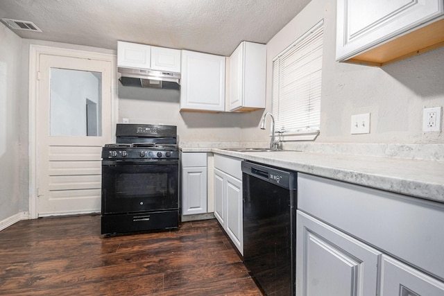 kitchen featuring a textured ceiling, white cabinetry, a sink, dark wood finished floors, and black appliances