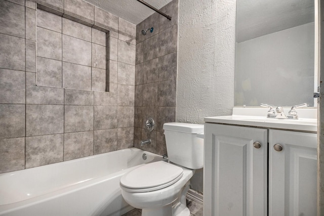bathroom featuring a textured wall, washtub / shower combination, vanity, toilet, and a textured ceiling