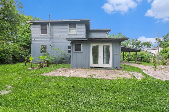 rear view of house featuring french doors and a yard