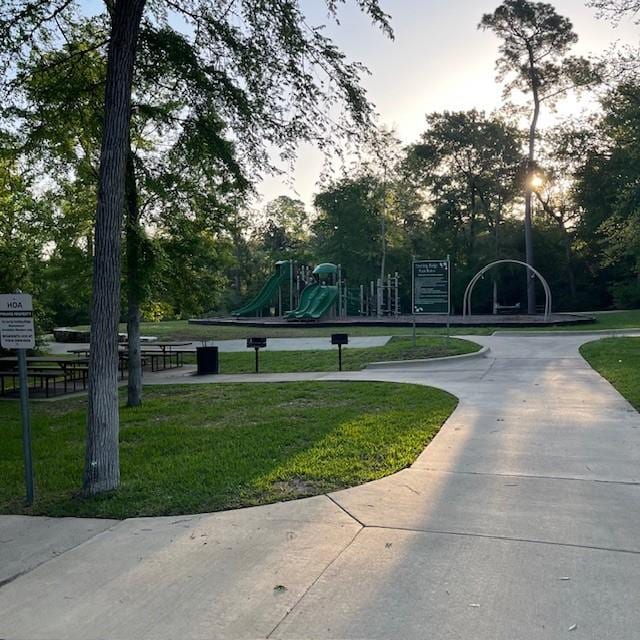 view of home's community featuring a yard and playground community