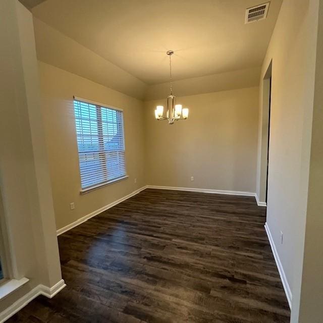 unfurnished dining area with visible vents, baseboards, dark wood-type flooring, and an inviting chandelier