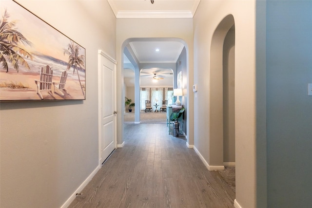 834 Arbor Pne, Tomball, TX 77375 - hallway with arched walkways, wood finished floors, crown molding, and baseboards