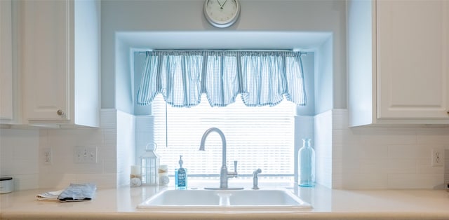 834 Arbor Pne, Tomball, TX 77375 - kitchen view of a sink, white cabinetry, light countertops, and tasteful backsplash