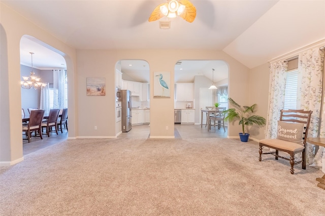 834 Arbor Pne, Tomball, TX 77375 - living area featuring light carpet, a chandelier, ceiling fan, baseboards, and arched walkways