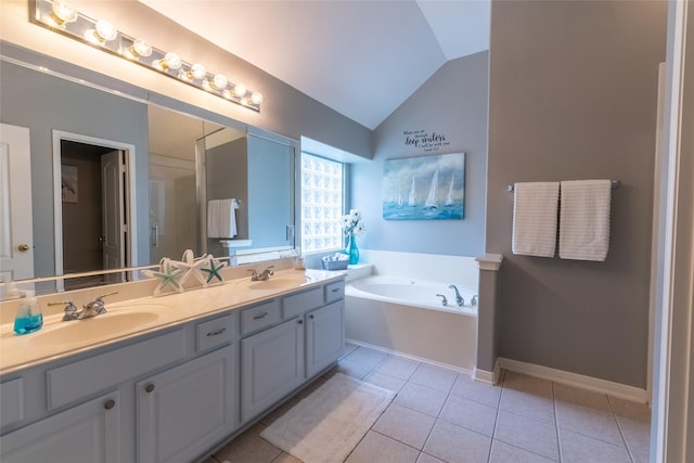834 Arbor Pne, Tomball, TX 77375 - bathroom featuring lofted ceiling, double vanity, tile patterned flooring, a garden tub, and baseboards
