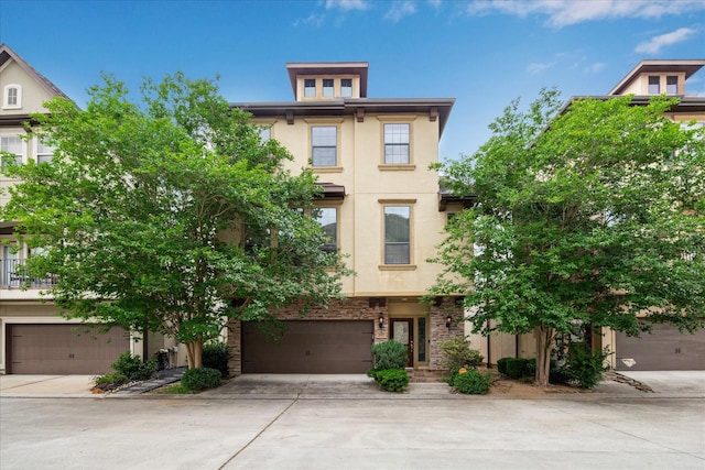 2707 Kings Retreat Cir, Kingwood, TX 77345 - view of front of property featuring stucco siding, an attached garage, driveway, and stone siding