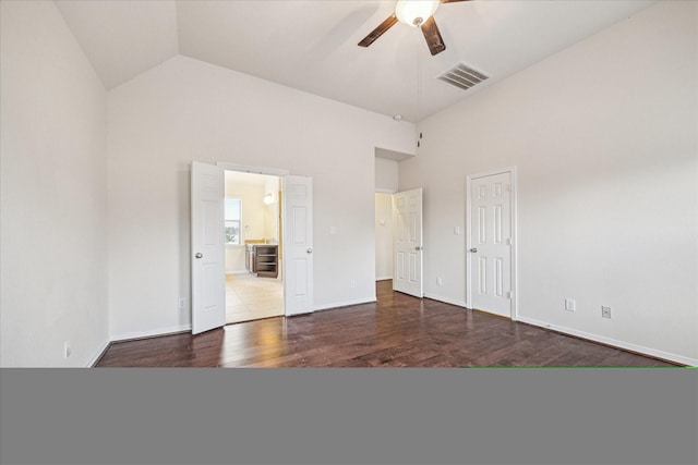 2707 Kings Retreat Cir, Kingwood, TX 77345 - unfurnished bedroom featuring connected bathroom, high vaulted ceiling, baseboards, wood finished floors, and visible vents