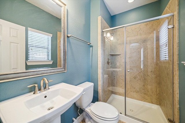 2707 Kings Retreat Cir, Kingwood, TX 77345 - bathroom featuring toilet, a shower stall, and a sink