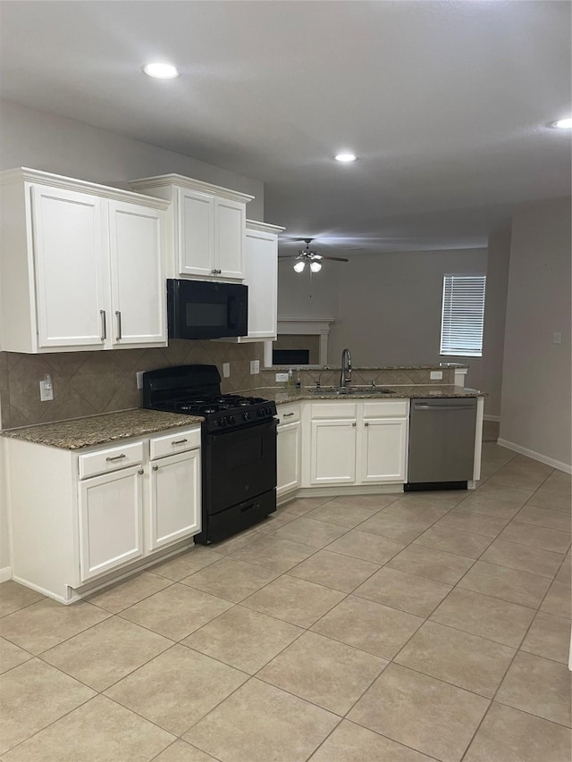 kitchen with a ceiling fan, backsplash, a sink, black appliances, and white cabinetry
