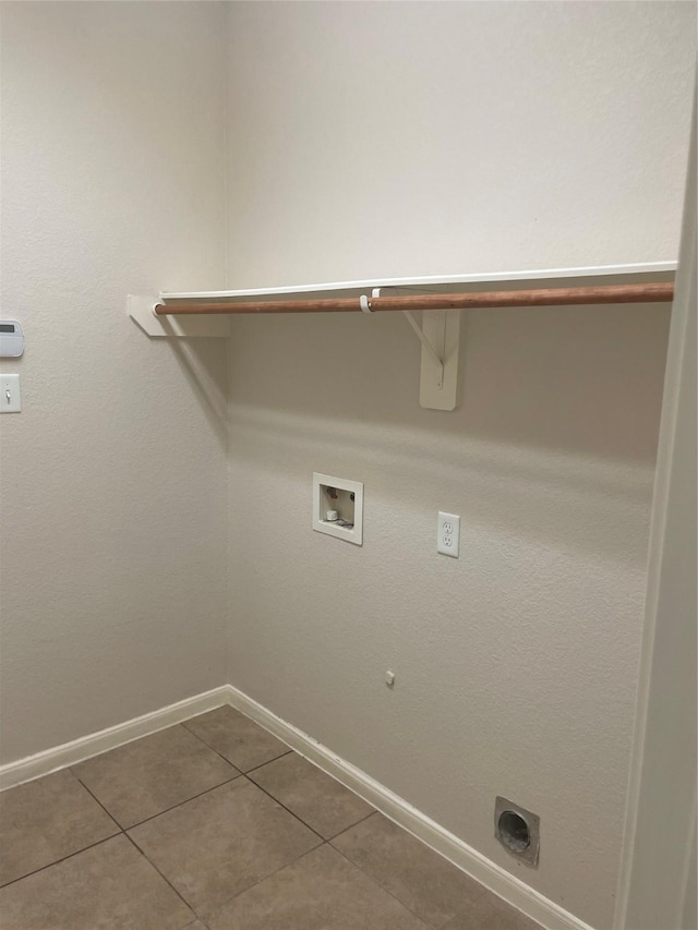 laundry area featuring washer hookup, hookup for an electric dryer, laundry area, tile patterned flooring, and baseboards