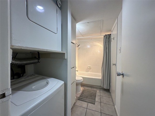 clothes washing area featuring laundry area, stacked washer and dryer, and light tile patterned flooring