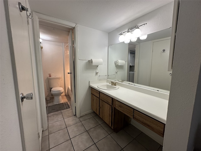 full bathroom featuring toilet, a textured ceiling, tile patterned flooring, and vanity