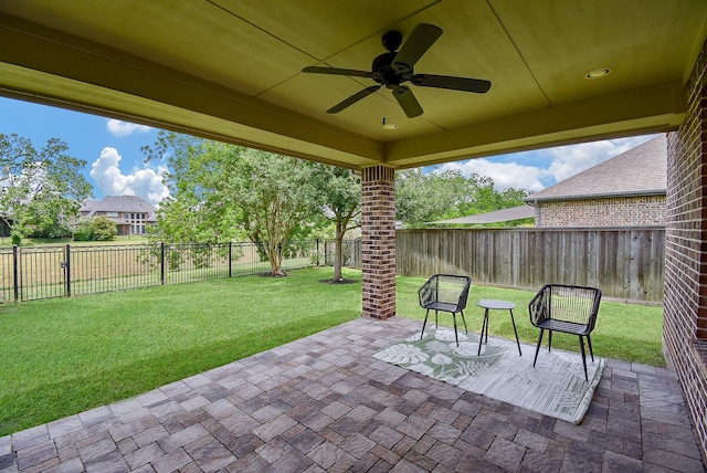 view of patio with a fenced backyard and ceiling fan