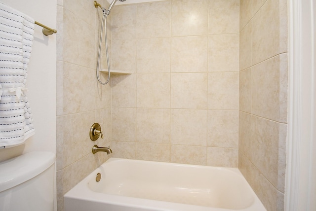 bathroom with shower / bathing tub combination and toilet