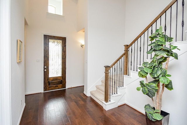6607 Nicholas Trl, Sugar Land, TX 77479 - entryway with wood-type flooring, a towering ceiling, stairs, and baseboards