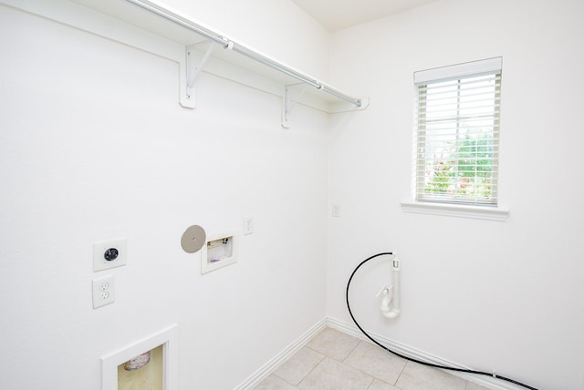washroom featuring laundry area, hookup for a washing machine, baseboards, electric dryer hookup, and light tile patterned floors