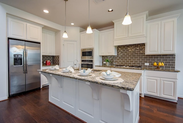 kitchen with white cabinets, dark wood-style flooring, and appliances with stainless steel finishes