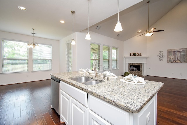 kitchen with a sink, a wealth of natural light, open floor plan, and dishwasher
