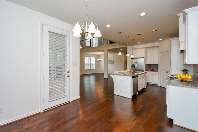 6607 Nicholas Trl, Sugar Land, TX 77479 - kitchen featuring stainless steel appliances, a chandelier, dark wood-type flooring, recessed lighting, and white cabinetry