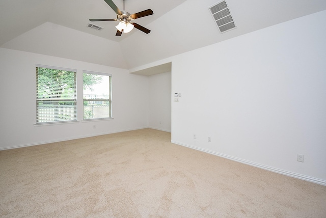 unfurnished room featuring vaulted ceiling, ceiling fan, light colored carpet, and visible vents