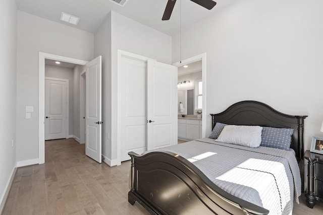 bedroom with ensuite bath, light wood-style floors, recessed lighting, baseboards, and visible vents