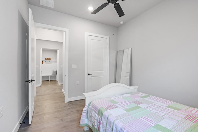 bedroom featuring a ceiling fan, baseboards, visible vents, and light wood-style floors