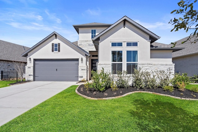 view of front of home with concrete driveway, stucco siding, a front yard, and stone siding