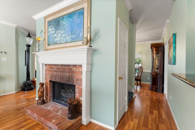 interior space with crown molding, baseboards, a fireplace, and wood finished floors