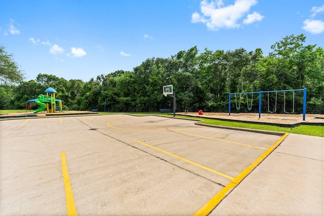 surrounding community featuring uncovered parking, community basketball court, and playground community