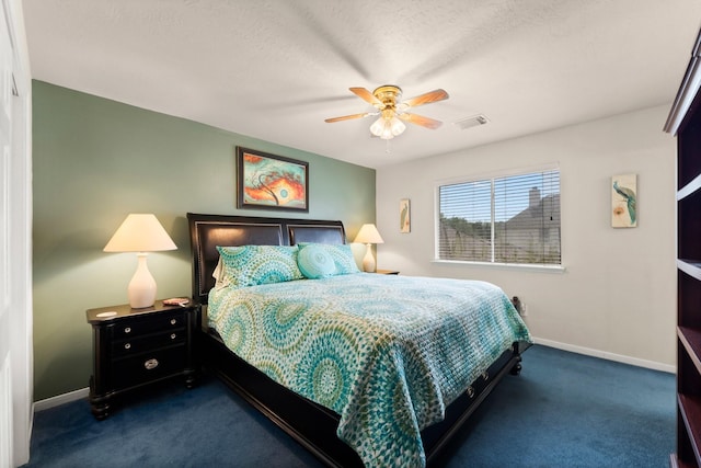 carpeted bedroom featuring a ceiling fan, baseboards, and visible vents