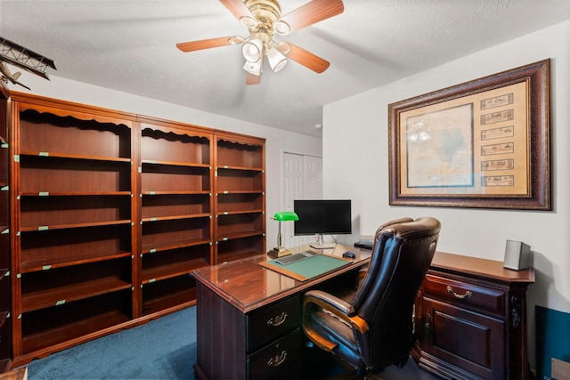 office area with ceiling fan and carpet