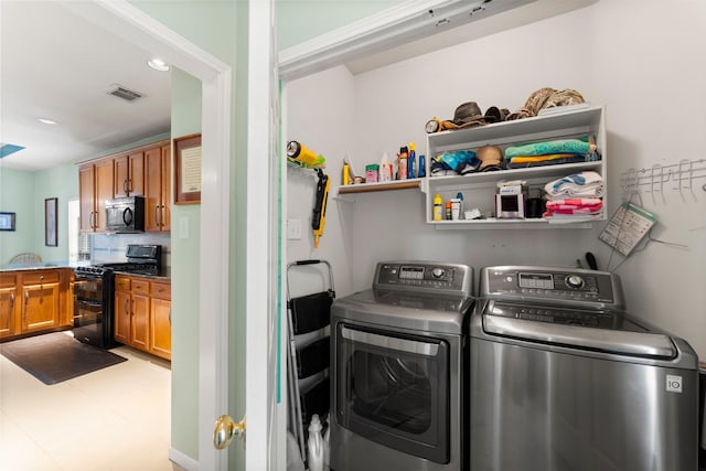 laundry area with independent washer and dryer, recessed lighting, and visible vents