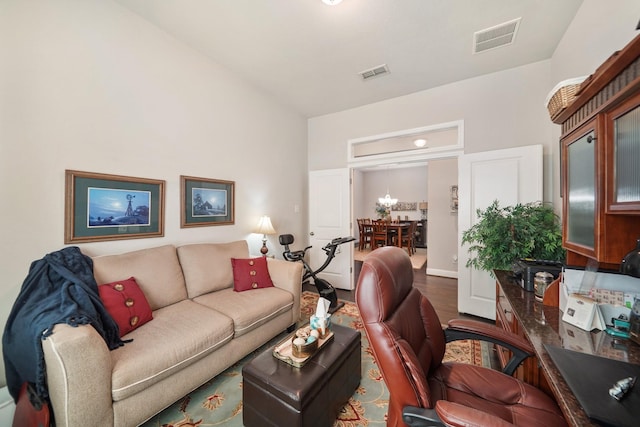 living room featuring visible vents and wood finished floors