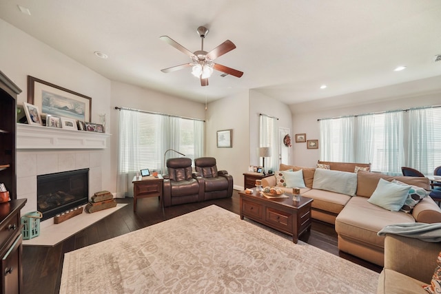 living area featuring visible vents, hardwood / wood-style floors, ceiling fan, recessed lighting, and a tiled fireplace