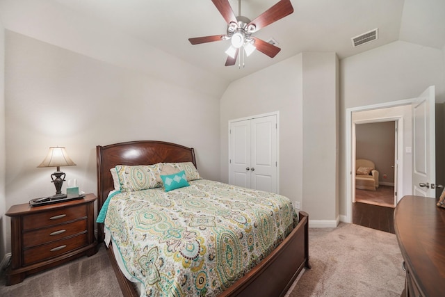 carpeted bedroom with ceiling fan, visible vents, vaulted ceiling, baseboards, and a closet