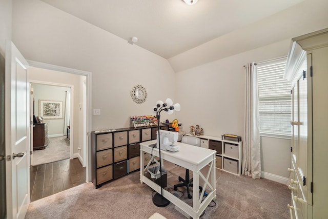 office space featuring carpet floors, baseboards, and vaulted ceiling