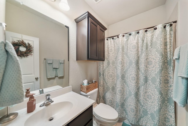 bathroom with vanity, a shower with shower curtain, and toilet