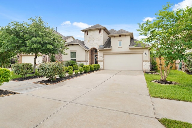 view of front facade featuring driveway, fence, a front lawn, stone siding, and stucco siding