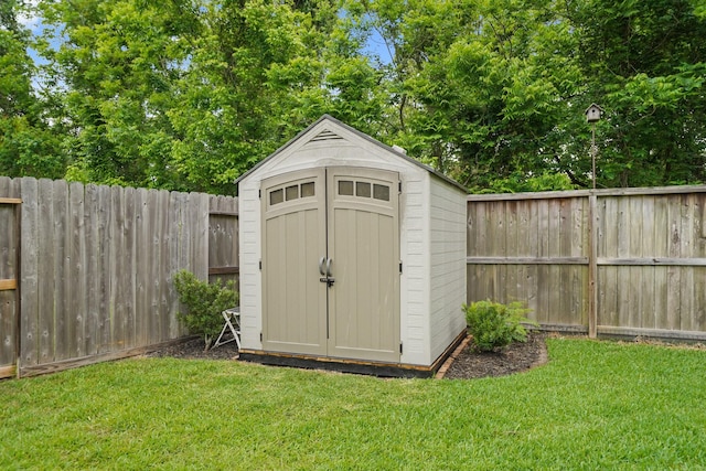 view of shed with a fenced backyard