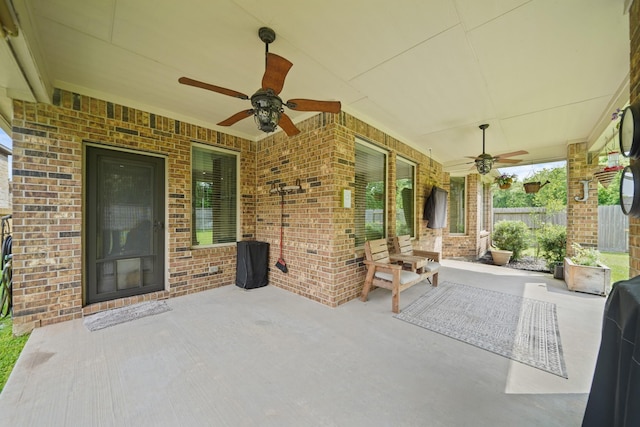 view of patio / terrace with ceiling fan and fence