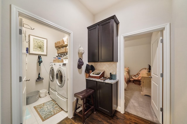 laundry room with laundry area, dark wood-type flooring, and washing machine and dryer