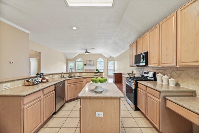 19814 Wren Forest Ln, Houston, TX 77084 - kitchen featuring a kitchen island, appliances with stainless steel finishes, a sink, and light brown cabinets
