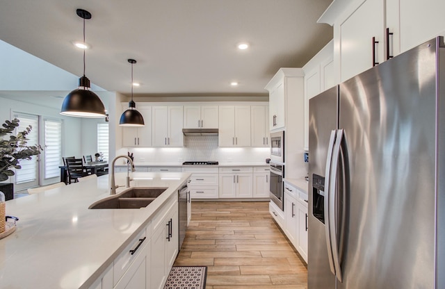 19018 Valentine Padlock Cir, Tomball, TX 77377 - kitchen featuring appliances with stainless steel finishes, a sink, light countertops, white cabinetry, and recessed lighting