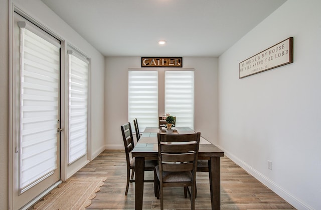 dining space with baseboards, recessed lighting, and wood finished floors